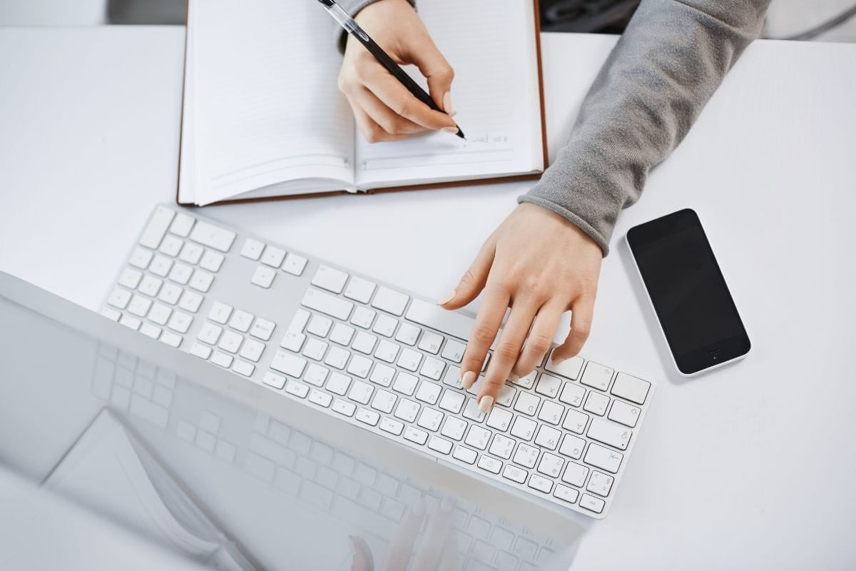 High angle shot of woman hands typing on keyboard