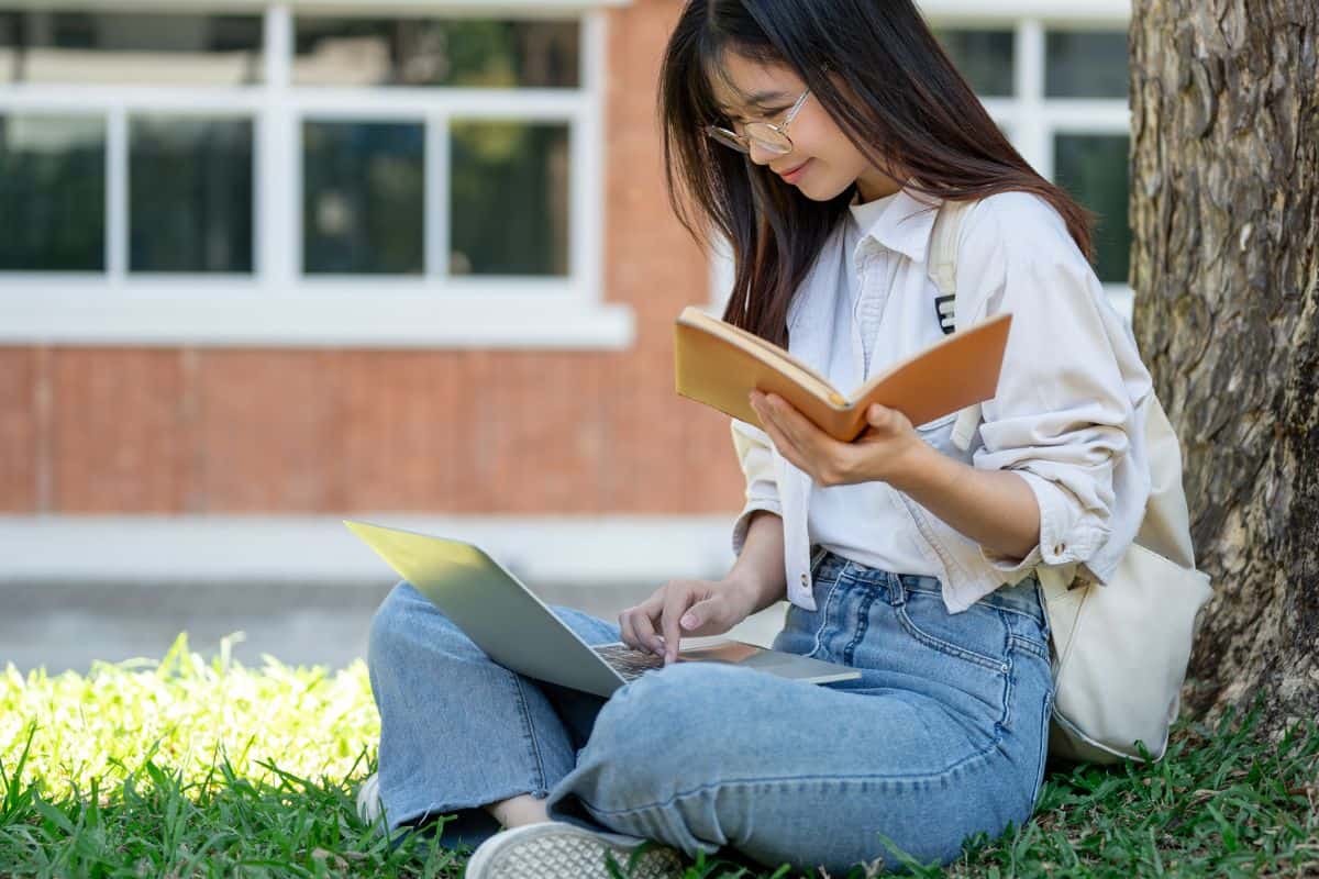 A beautiful young asian female college student is doing homework
