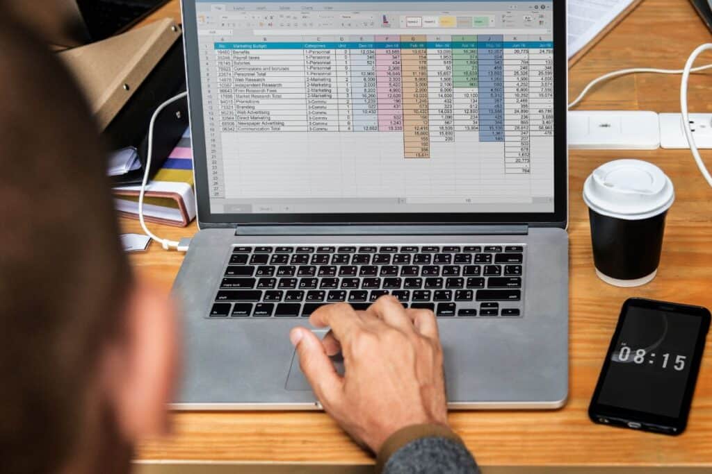 Businessman working a on laptop in a meeting