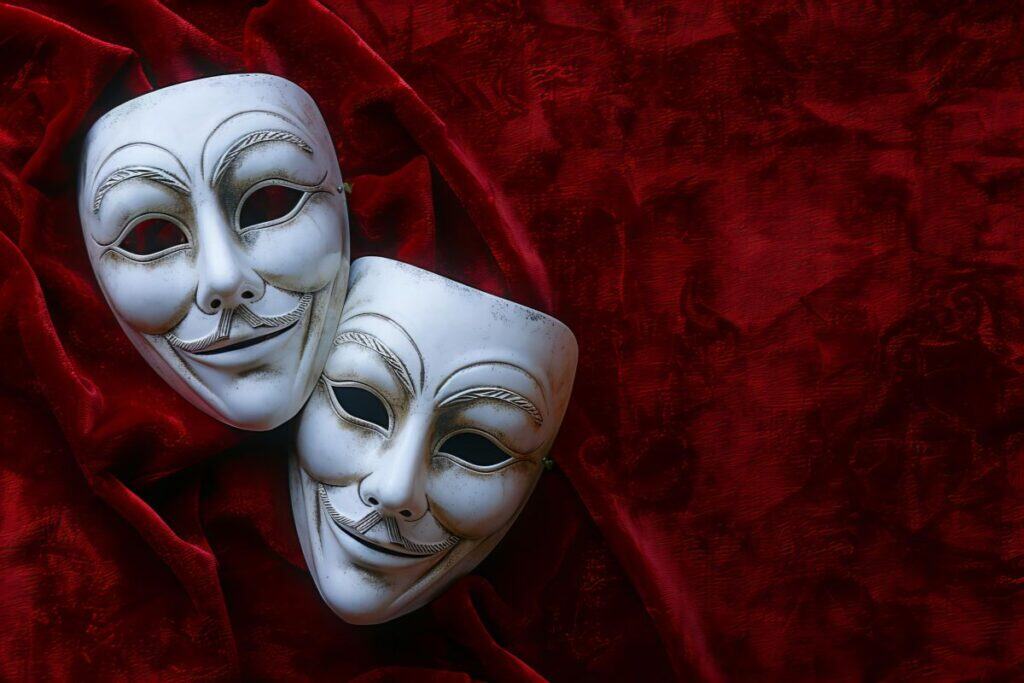 Un panno rosso con maschere bianche con la scritta maschere