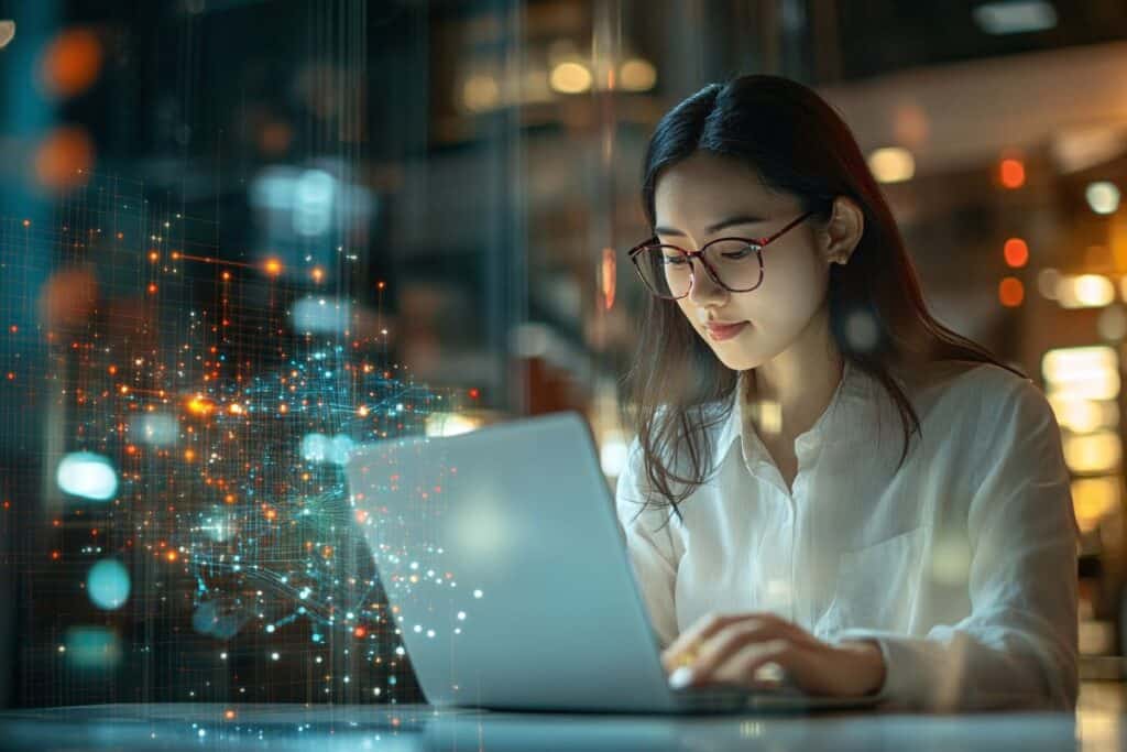 Woman working on a laptop in a dark room