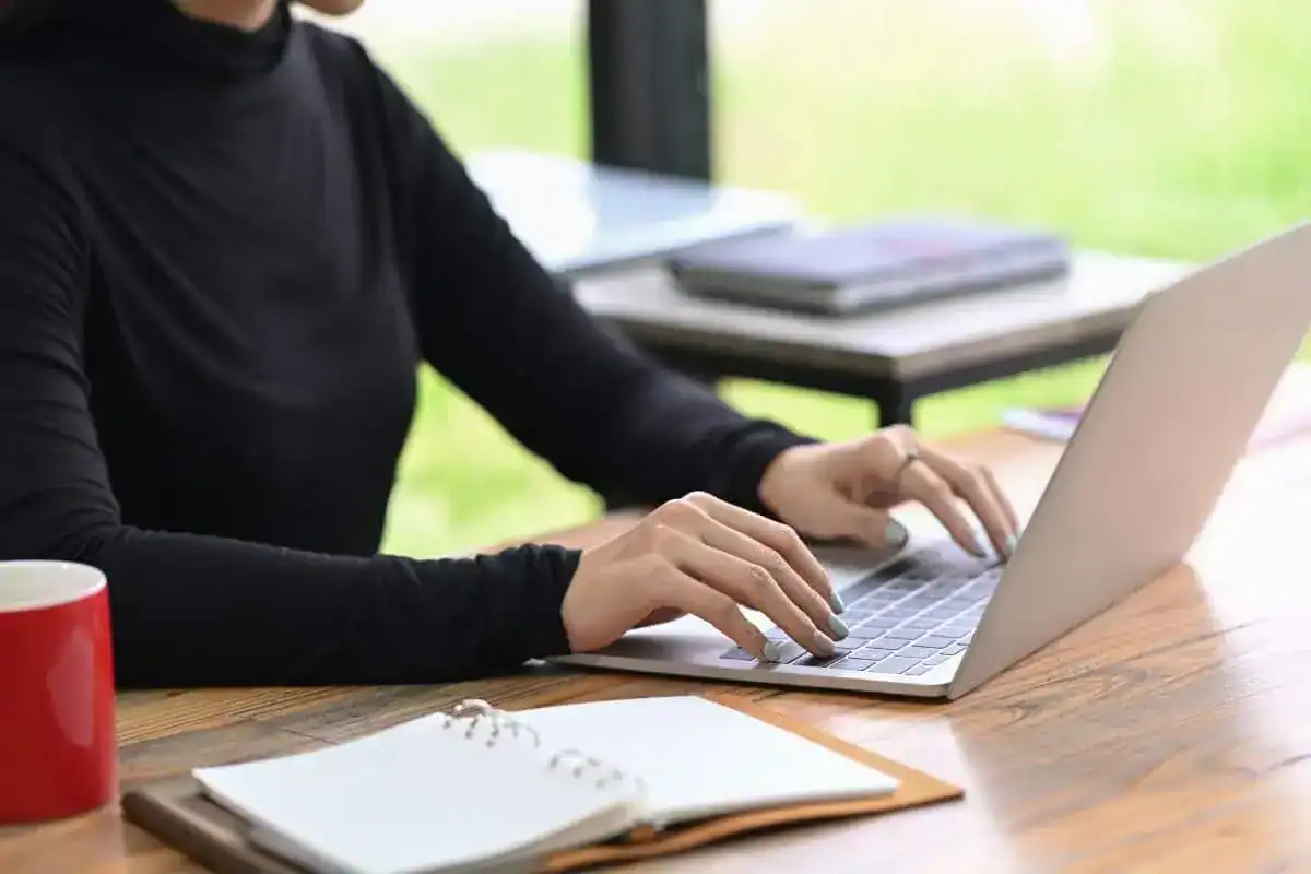 Cropped shot stylish woman working with laptop computer