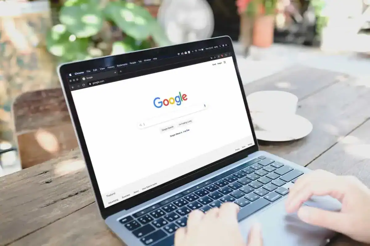 a woman is typing on google search engine