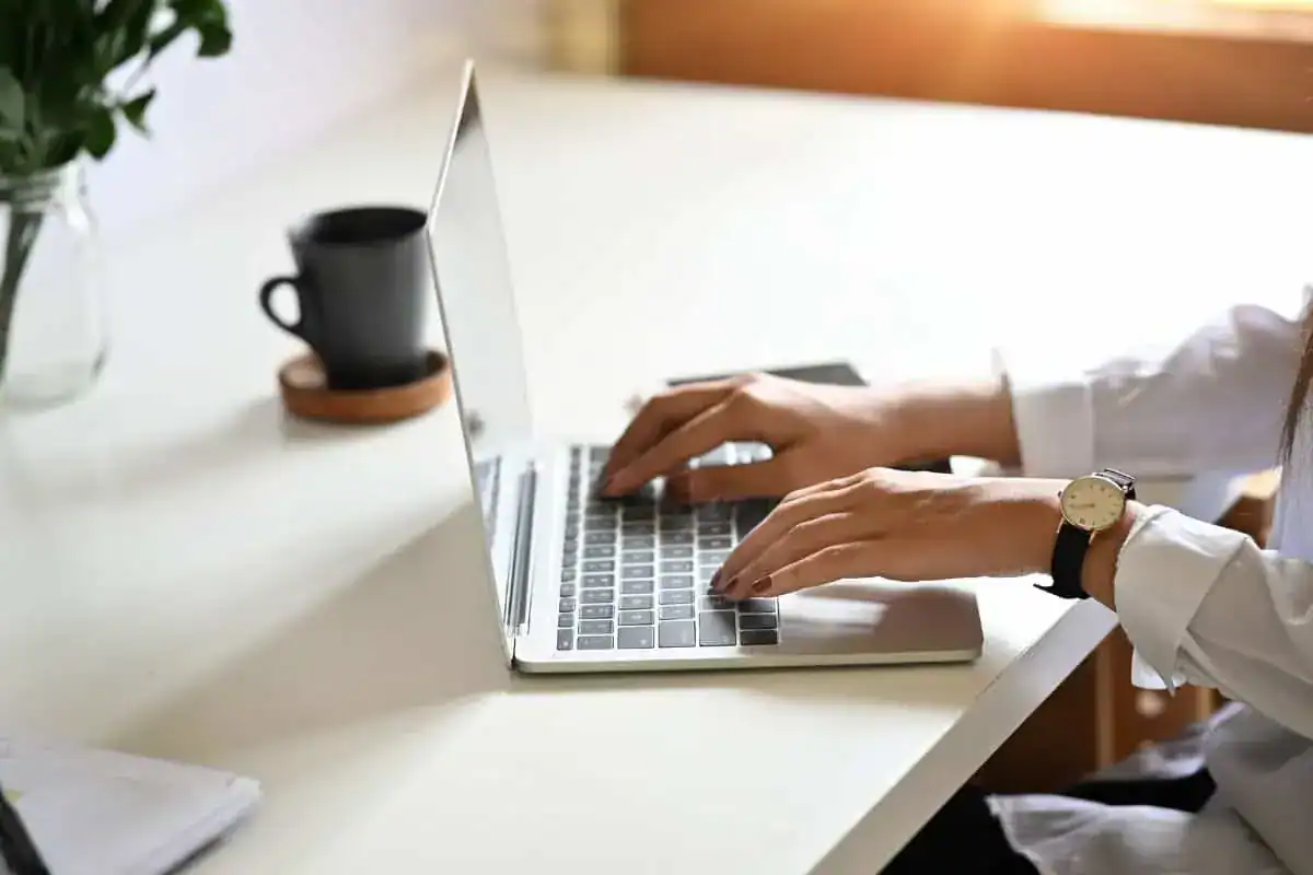 Young female freelance working using a laptop on office desk