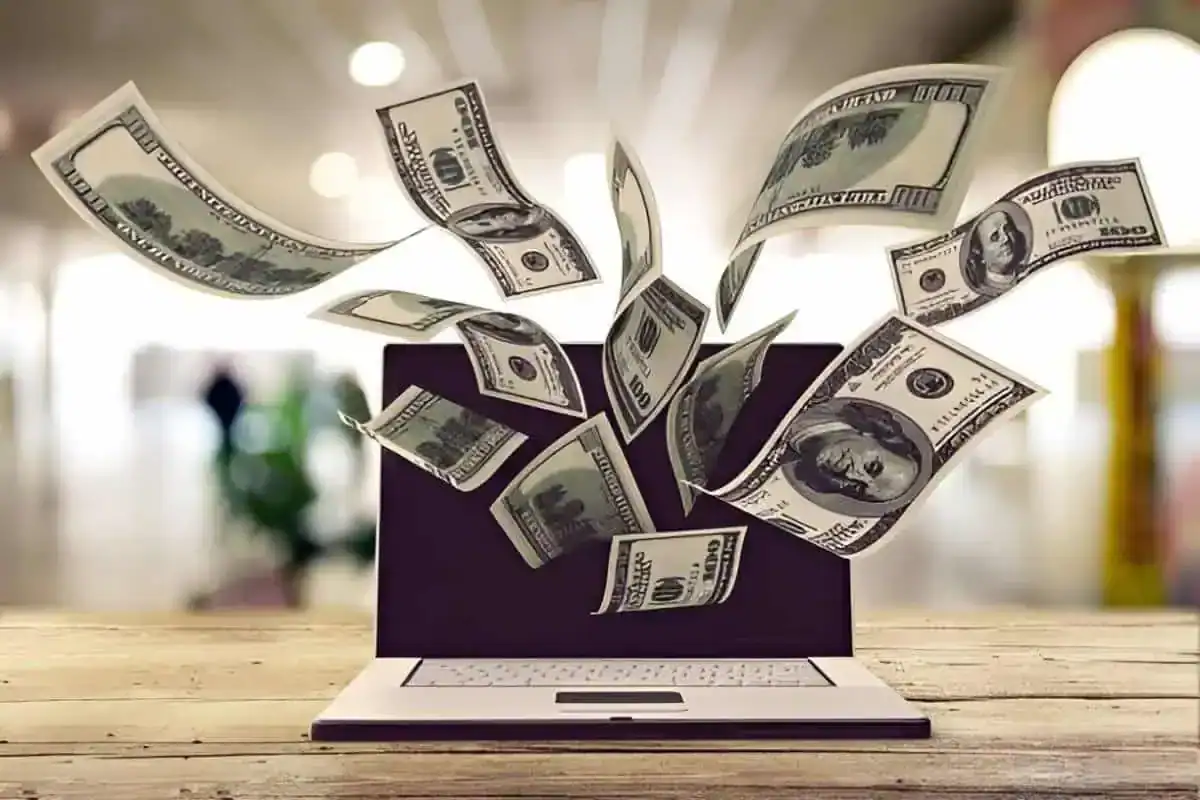 Illustration of dollars flying out from a laptop screen