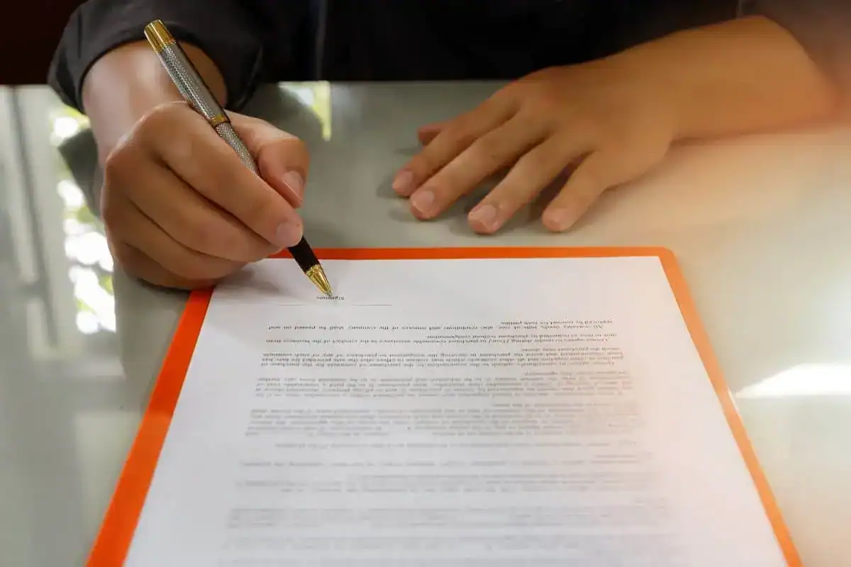 Close up of business man signing contract making a deal