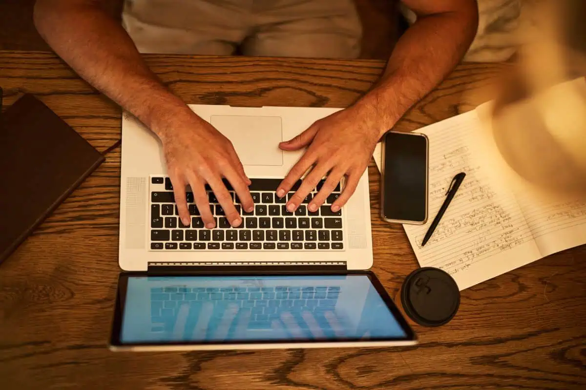 Cafe student and hands on keyboard laptop
