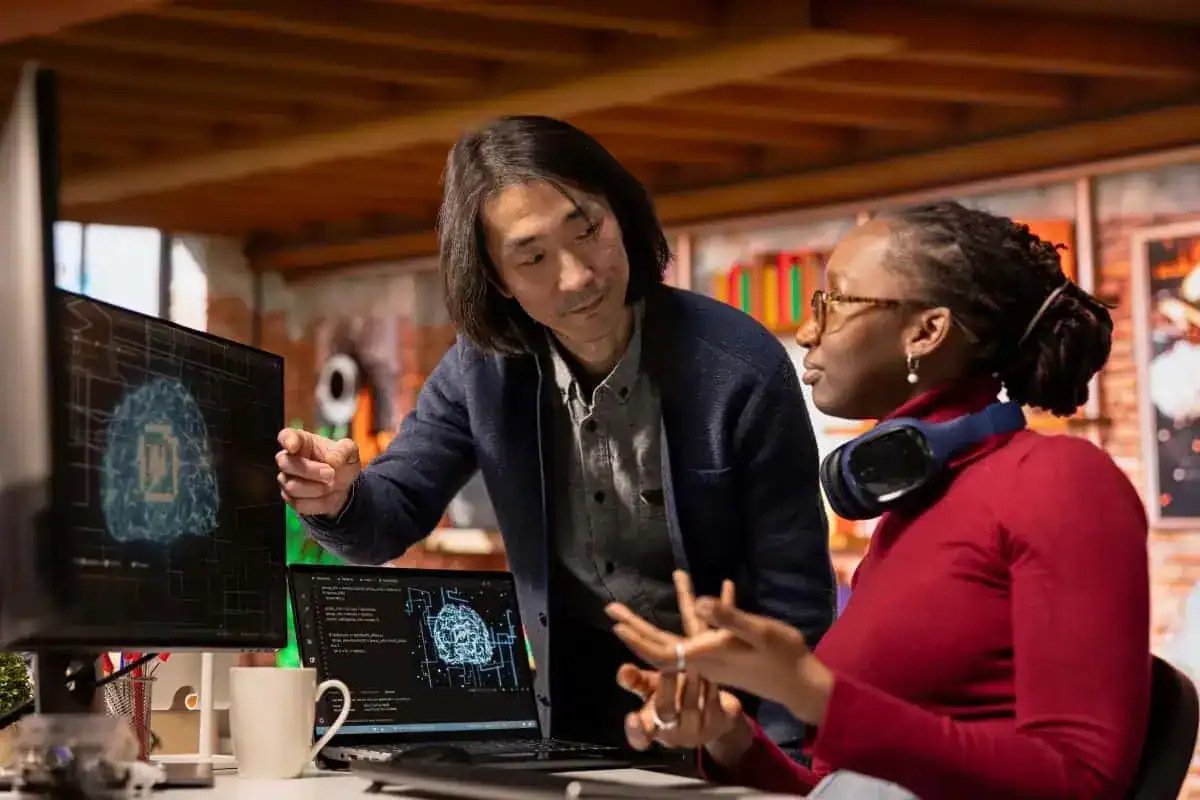 Senior manager assisting worker in ai software development agency