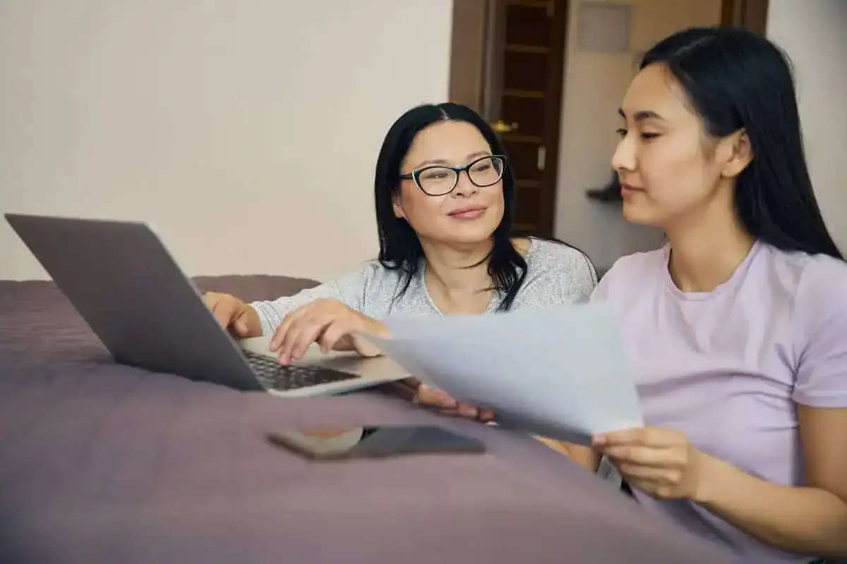 Family of two making online bill payment using laptop