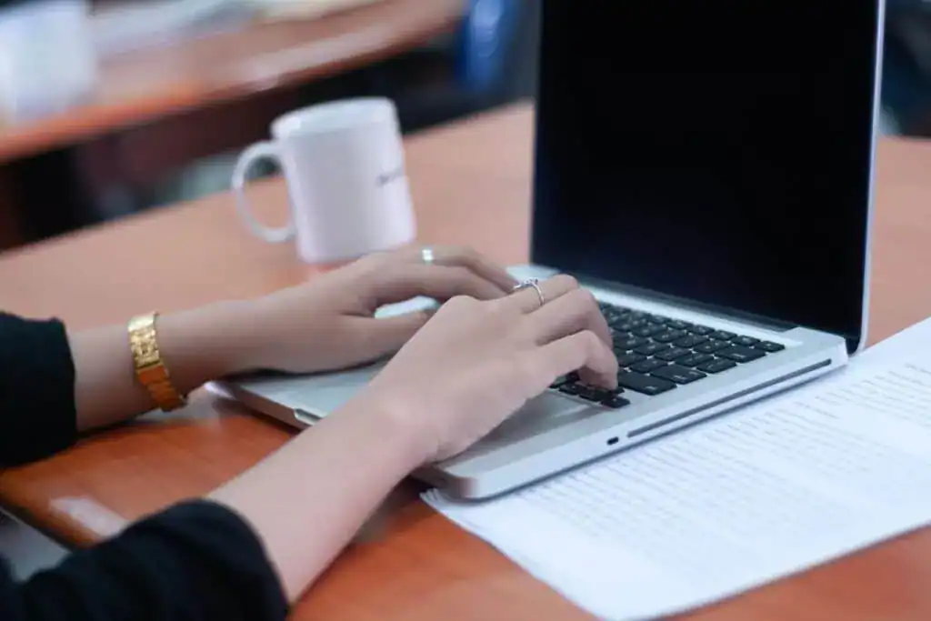 Hands typing on a computer keyboard