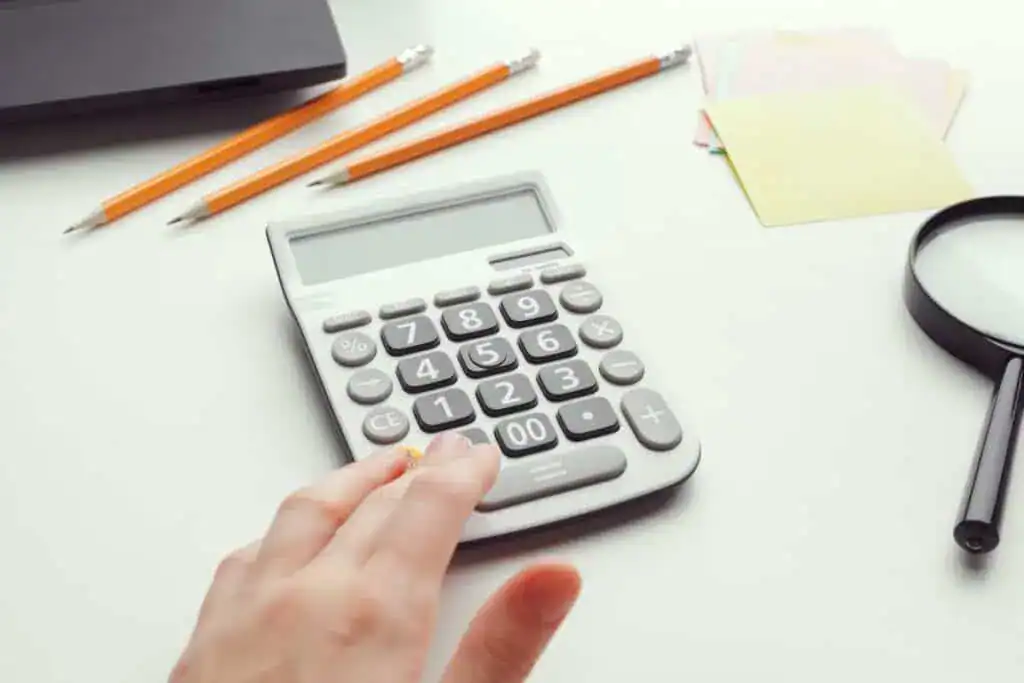 Business woman working with financial data hand using calculator