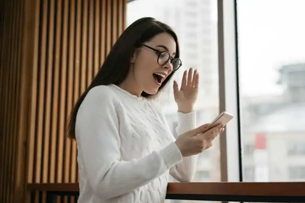 Surprised woman holding mobile phone