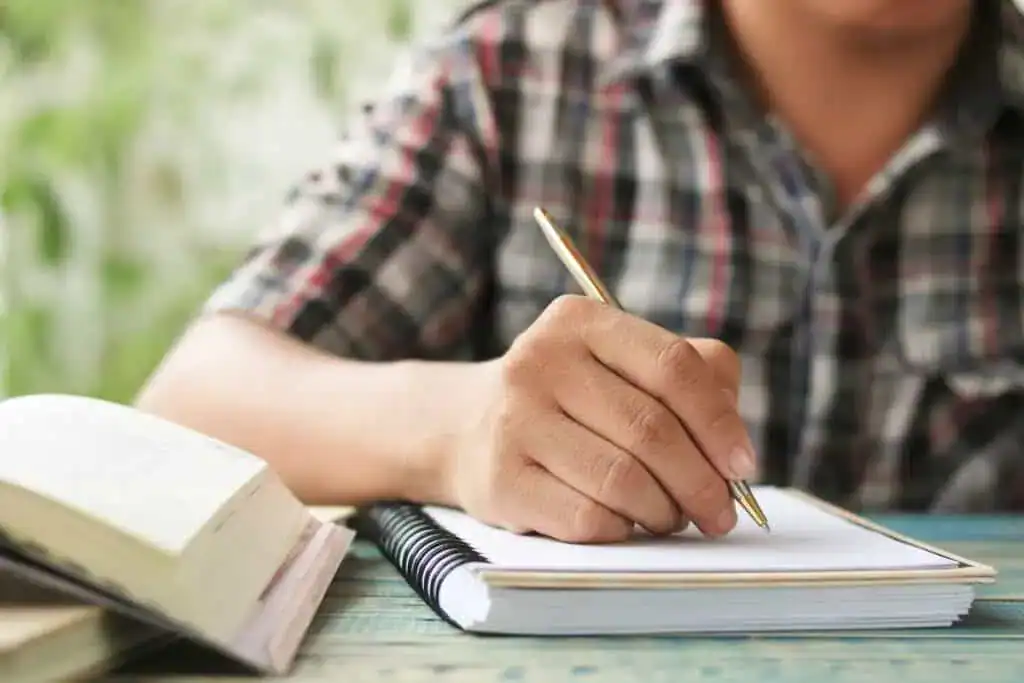 Man writing on notebook