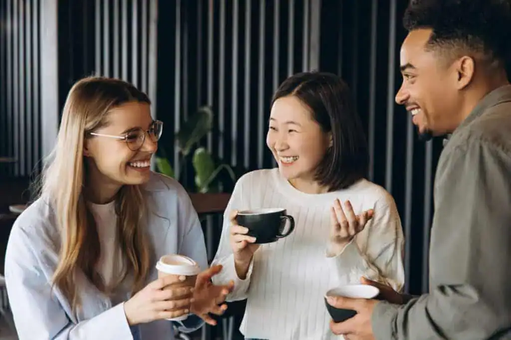 Diverse business team enjoying coffee break and sharing conversation