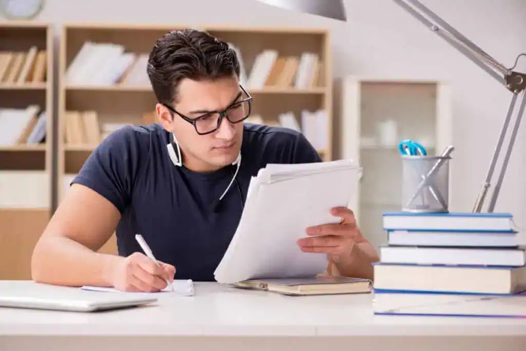Happy male student preparing for his exams
