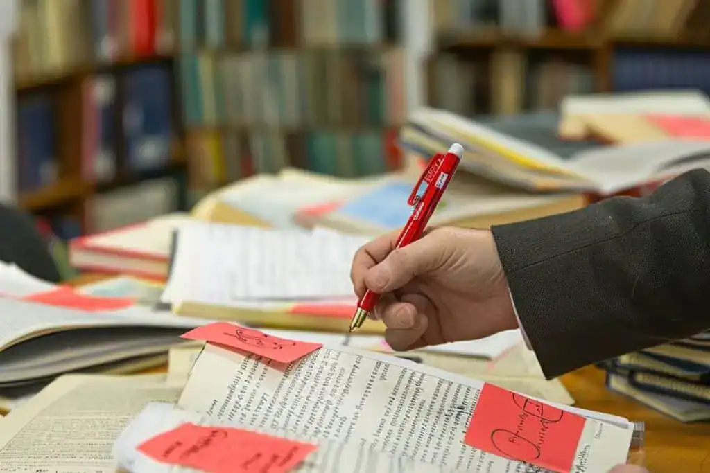 Editor marking corrections on printed manuscript