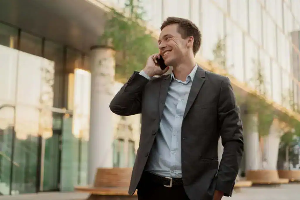A manager in a business suit uses a phone the financier goes to work