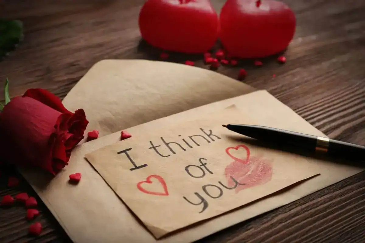 Gift card for valentine's day with inscription red rose pen and candles
