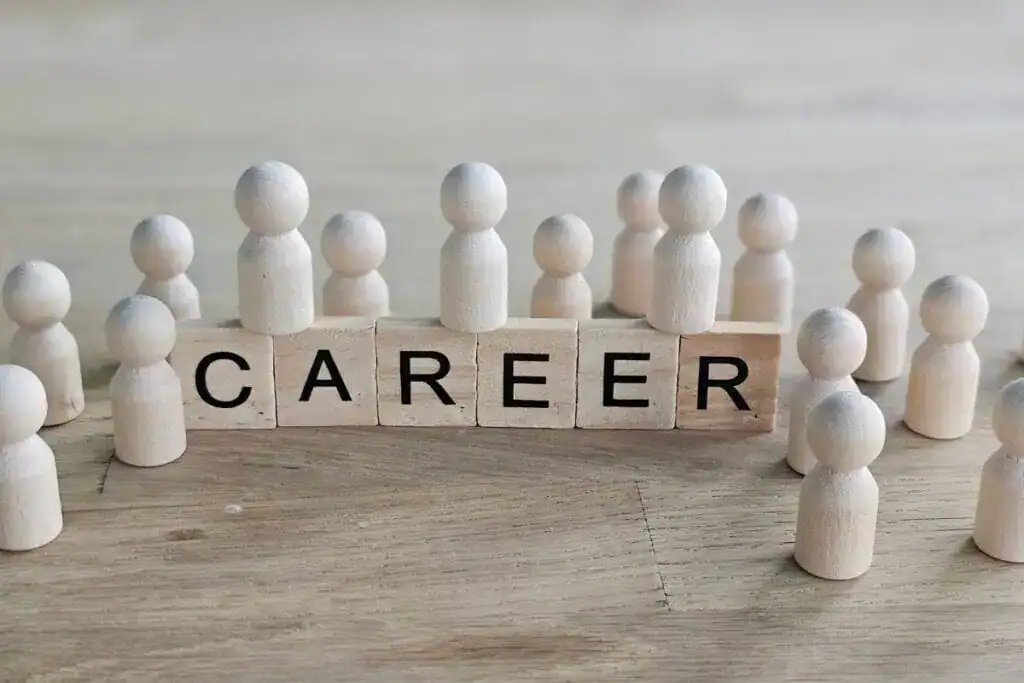 How to Choose a Career That’s Right for You 4 People made of wood gather around blocks that spell career