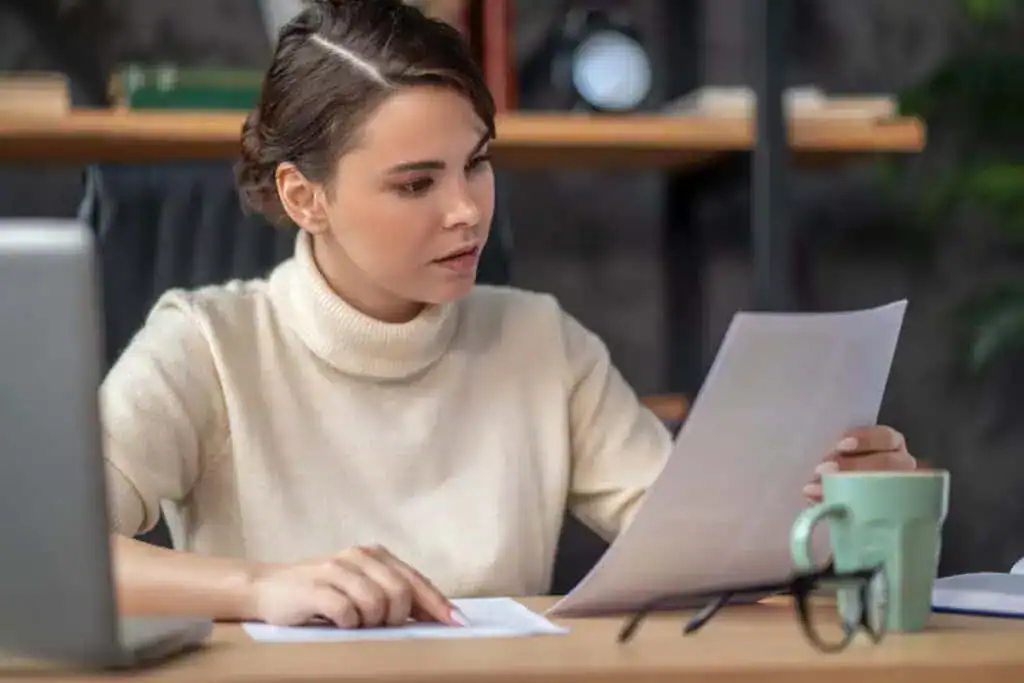 Concentrated lady examining documentation
