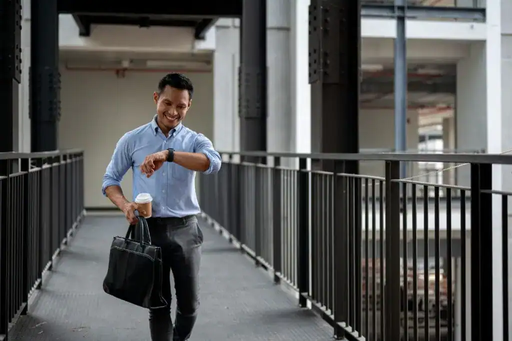 A confident asian businessman is checking time