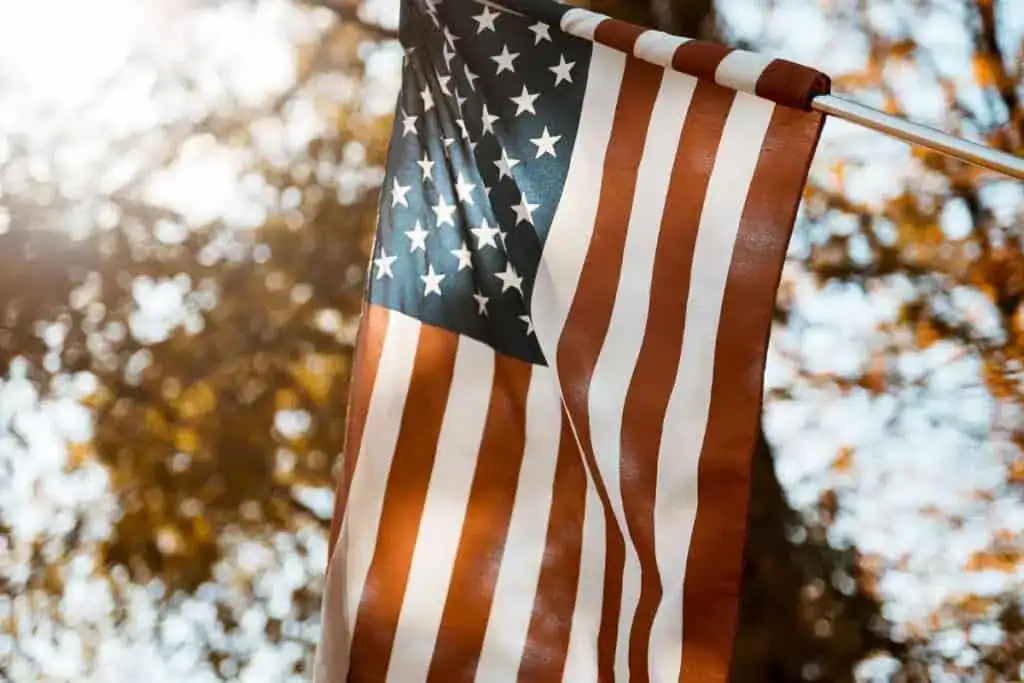 Flag of the united states in a vertical shot with a blurred