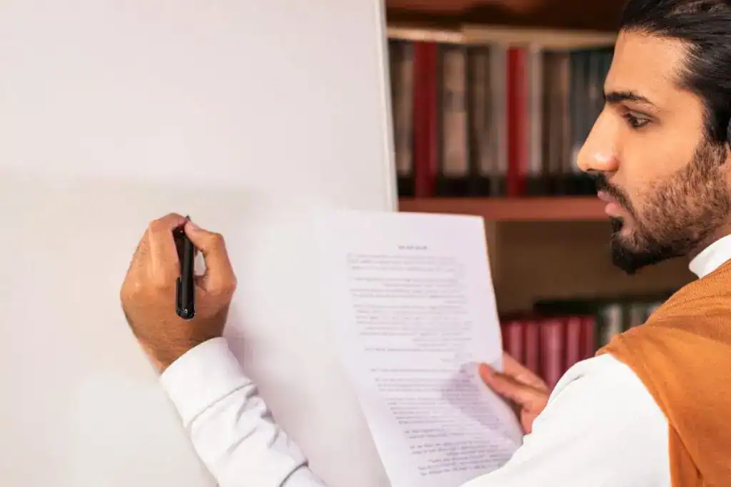 Arab teacher man teaching english language writing grammar rules