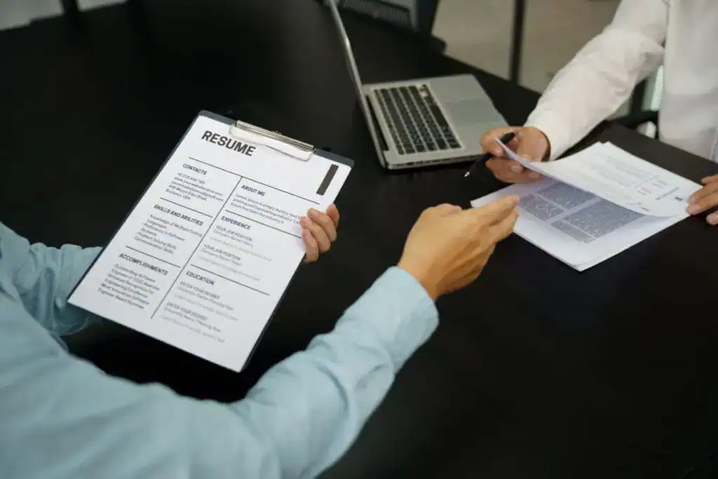 Examiner reading a resume during job interview at office business 