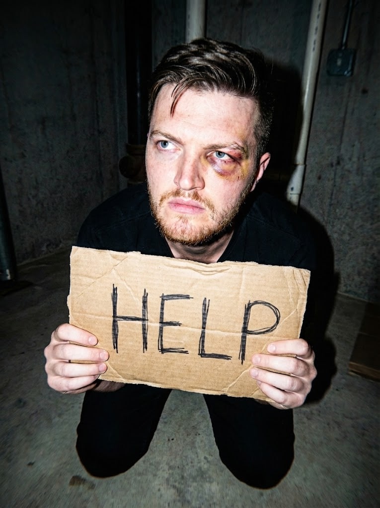 Ich habe 5 AI-Bilddetektoren getestet. Dies sind die besten im Jahr 2026: 13 Ein KI-generiertes Bild eines Mannes, der ein Schild mit der Aufschrift "Hilfe" hält